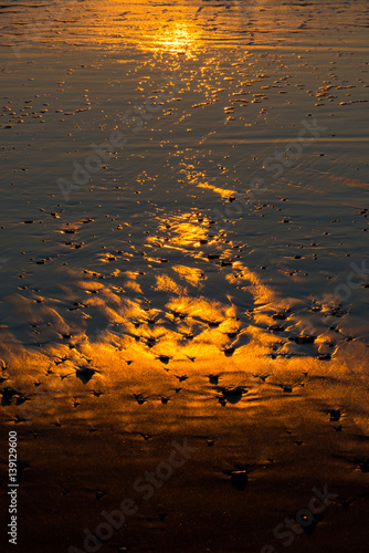 Reflections on the beach at sunset