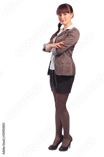 Full length of cheerful business woman standing with arms folded