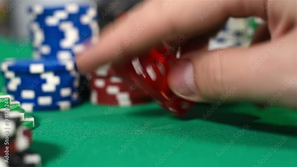 Dealer Hand Holding Two Dice On Green Table, Close Up Dealer Hand Holding Two Dice On Green Table, Close Up