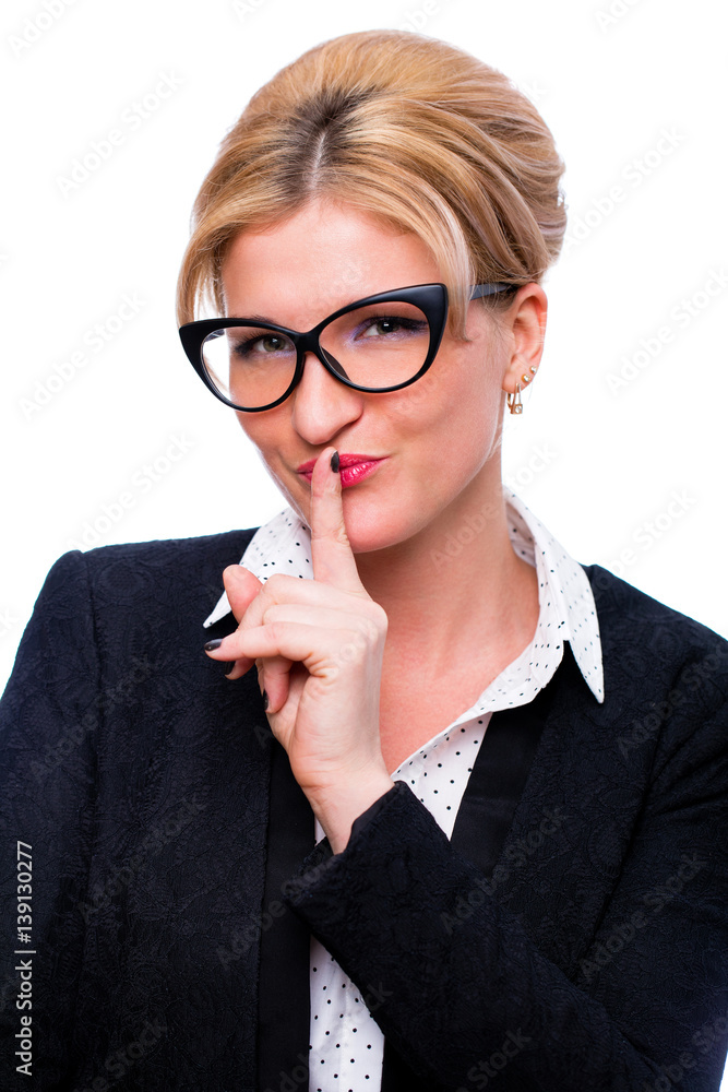 Young beautiful woman has put forefinger to lips as sign of silence Young beautiful woman has put forefinger to lips as sign of silence