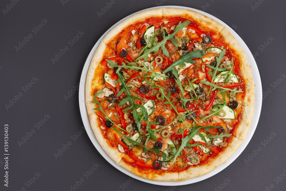Lean pizza Margherita with cheese, arugula, tomato sauce on a white plate. Space for text. Lean pizza Margherita with cheese, arugula, tomato sauce on a white plate. Space for text.