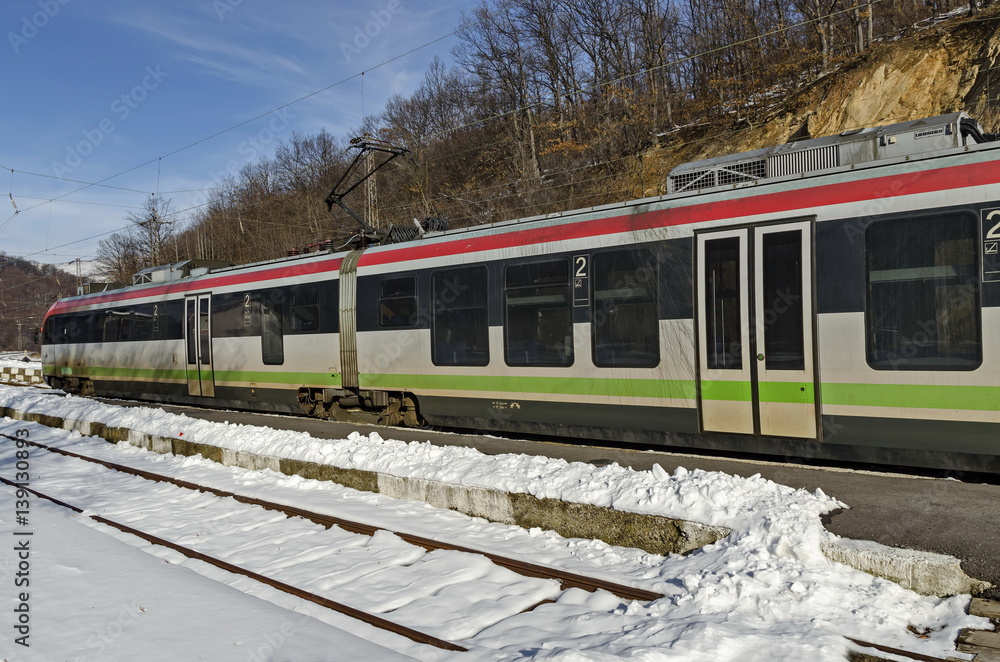Fototapeta premium Fast train passing through the train station, Koprivshtitsa, Bulgaria 