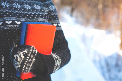 Books on the background of knitted sweaters.