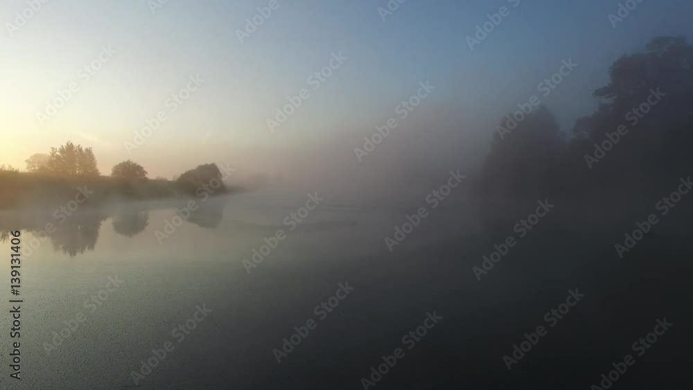 Village pond bloomed like a swamp. Bird over water. The camera moves very low over the marsh and rises through the morning mist over the village. Aerial view. Village pond bloomed like a swamp. Bird over water. The camera moves very low over the marsh and rises through the morning mist over the village. Aerial view.