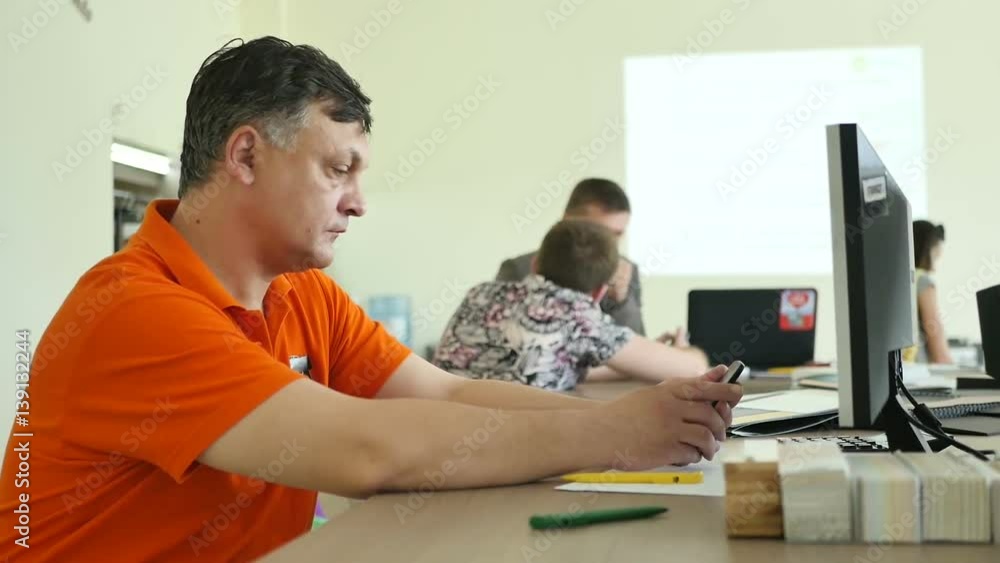 The salesman use the telephone at the workplace The salesman use the telephone at the workplace