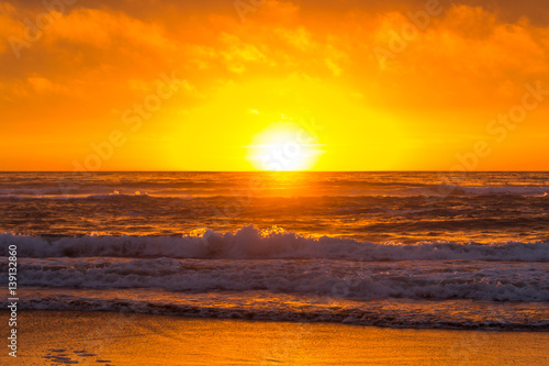 Fototapeta Naklejka Na Ścianę i Meble -  Deep Orange West Coast Sunset, Waves Crashing