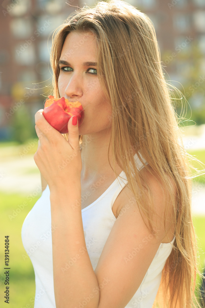 beautiful girl portrait holding apple. eating fruit beautiful girl portrait holding apple. eating fruit