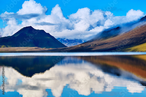 Lake coast with mountain reflection at the sunrise, Iceland