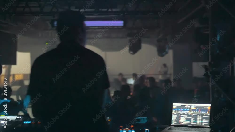 DJ Turns The Records at The Modern Nightclub, Back View, Slow Motion DJ Turns The Records at The Modern Nightclub, Back View, Slow Motion