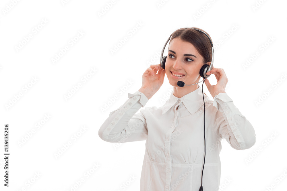young girl holding hands headphones on head looks away and smiling young girl holding hands headphones on head looks away and smiling