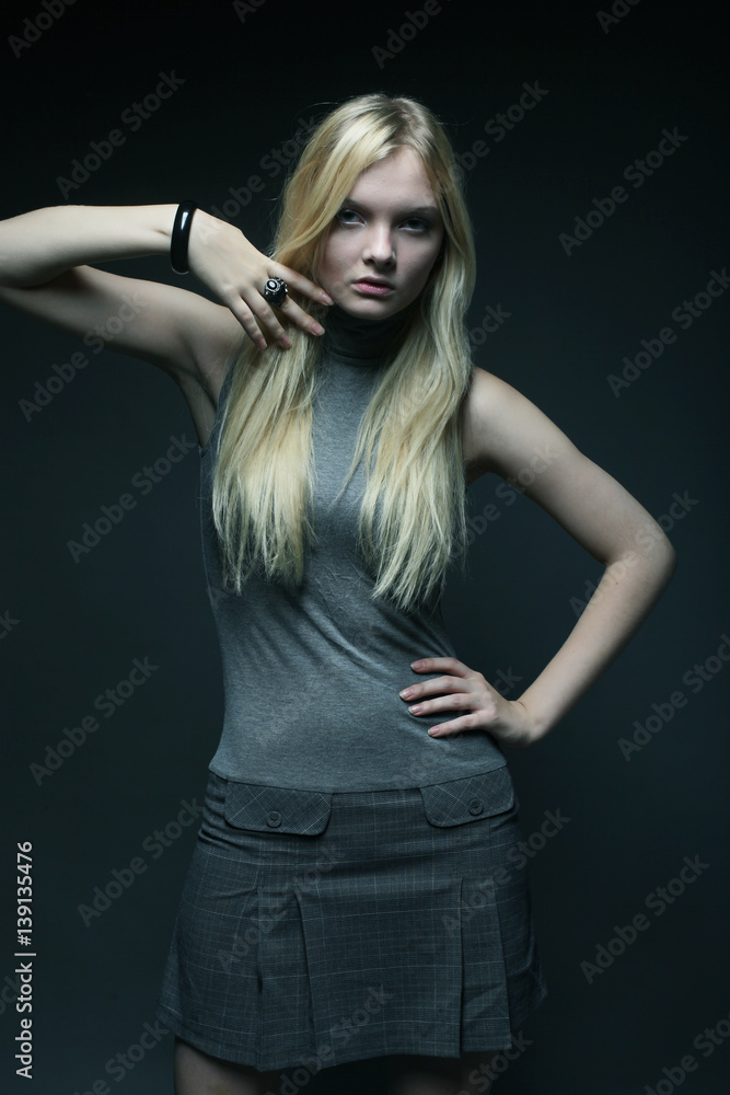 Portrait of beautiful young blonde girl in black dress. Portrait of beautiful young blonde girl in black dress.