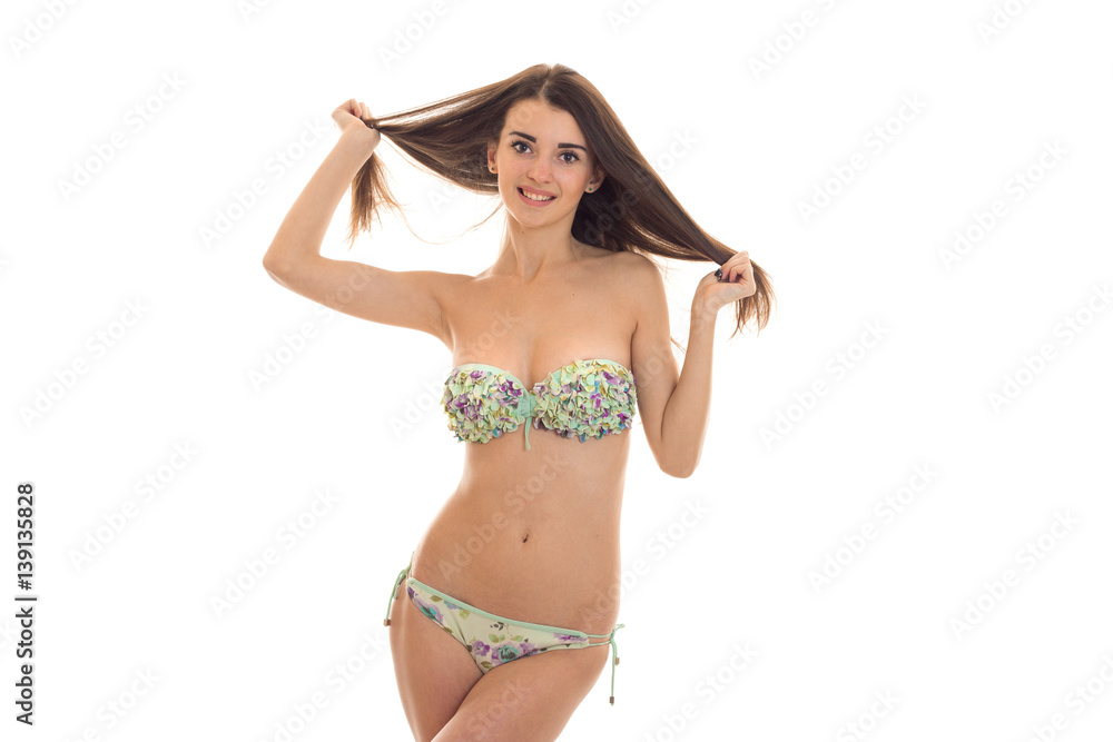 beautiful young girl in a bathing suit with big breasts smiling and holding  hands hair Stock Photo