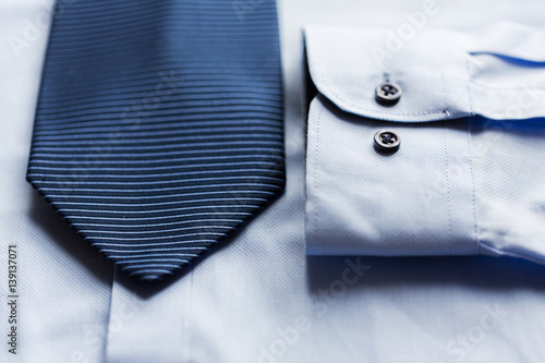 close up of shirt and blue patterned tie