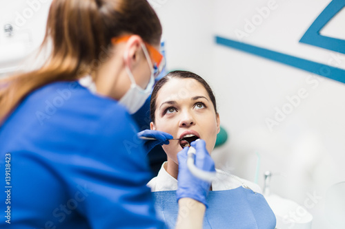 Young woman patient at a reception at the dentist