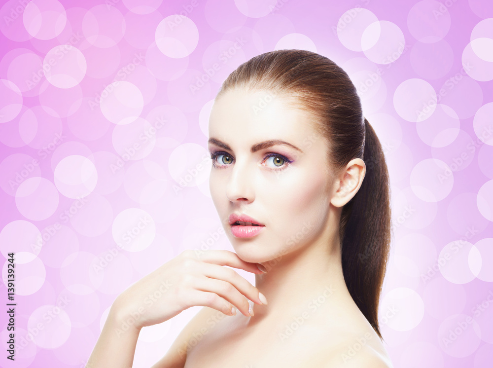 Naklejka premium Portrait of young, beautiful and healthy woman: over pink background. Healthcare, spa, makeup and face lifting concept.