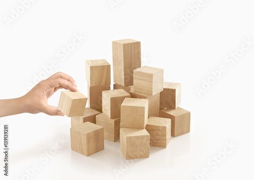 Single hand playing wooden box on isolated background.