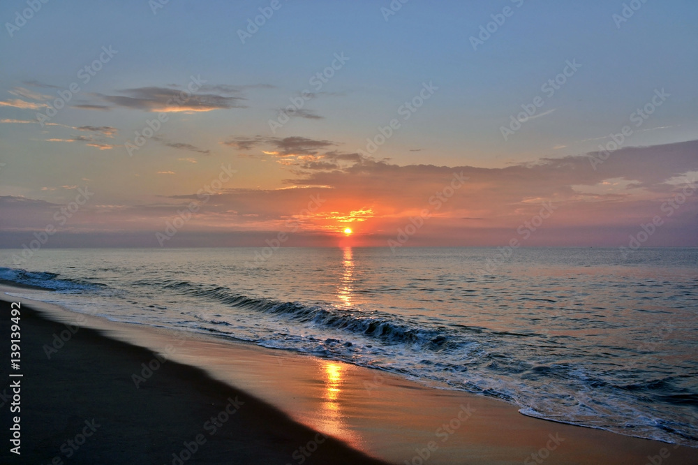 Fototapeta premium Golden and Glowing Sunrise at the Shore