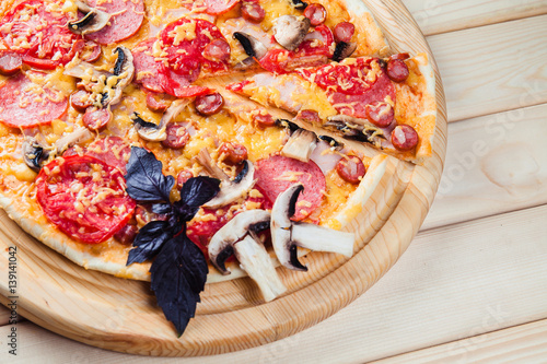 Mushroom pizza on the wooden background