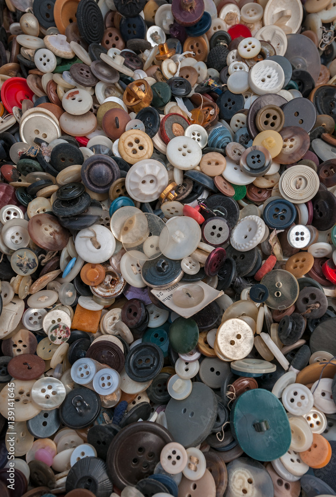 Plastic, Metal and Wood Buttons Piled in Box Plastic, Metal and Wood Buttons Piled in Box