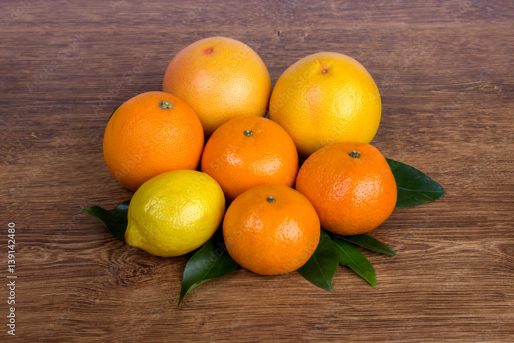  citrus fruit ( lemon, orange, grapefruit and tangerine) with leaves  