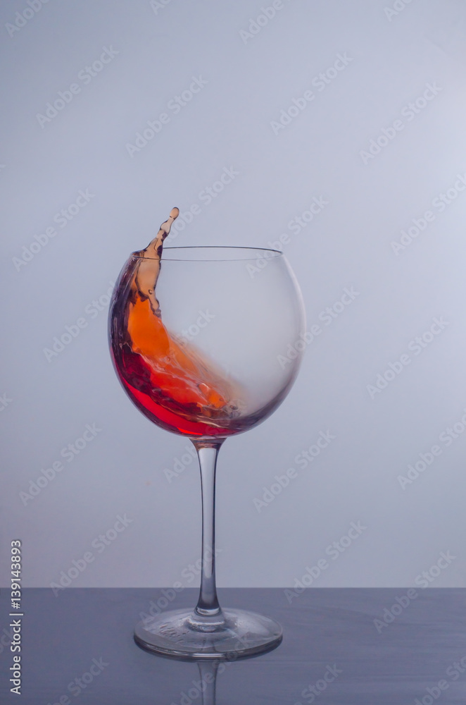splash of red wine in a glass splash of red wine in a glass