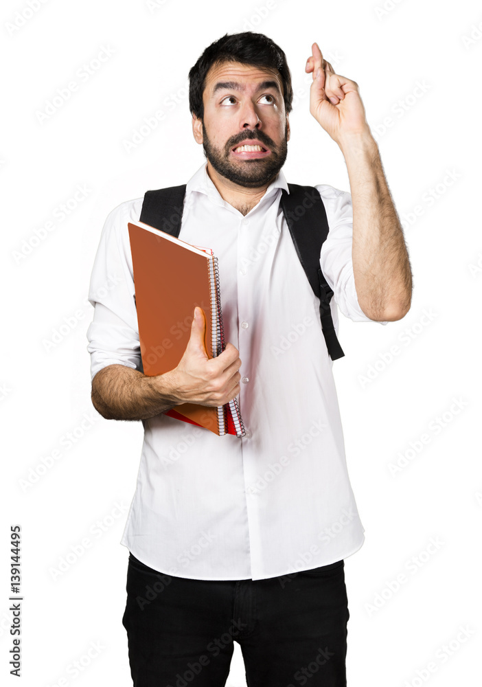 Student man with his fingers crossing Student man with his fingers crossing