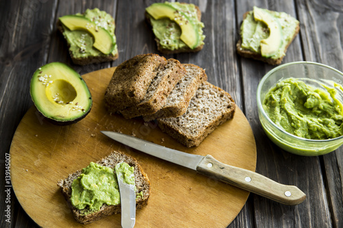 spread with a knife on a paste of avocado bread Greceanii. raw and healthy food for vegan photo