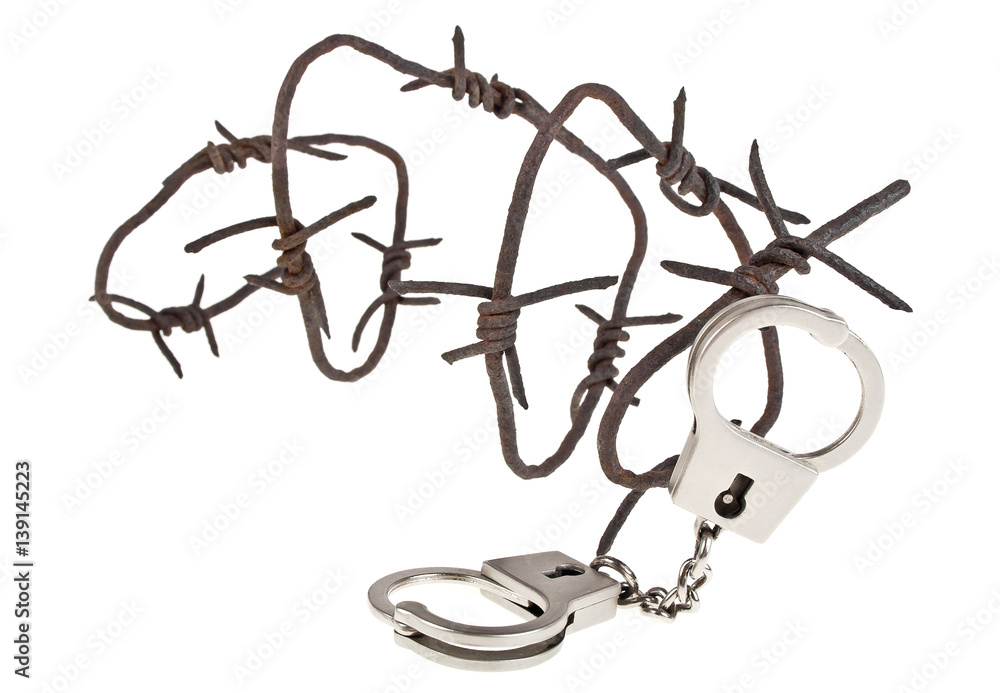 Rusty barbed wire and handcuffs on a white background Rusty barbed wire and handcuffs on a white background