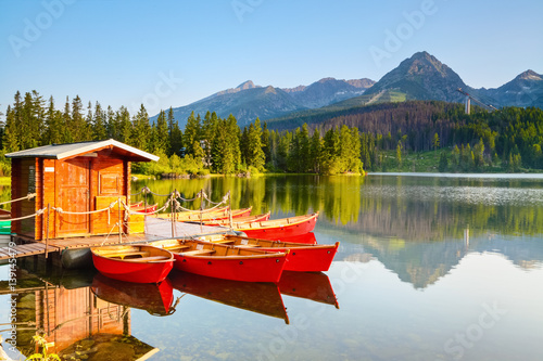 Dreamy boats stand near wooden bridge. photo