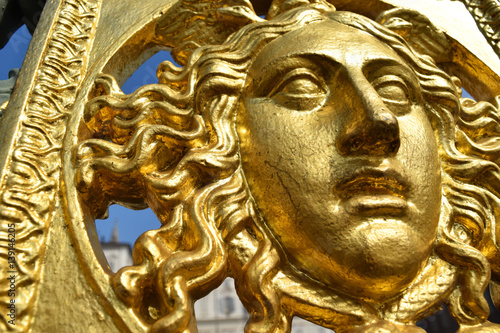 A golden face  detail of the original metal fence of the Royal Palace of Turin  Italy.