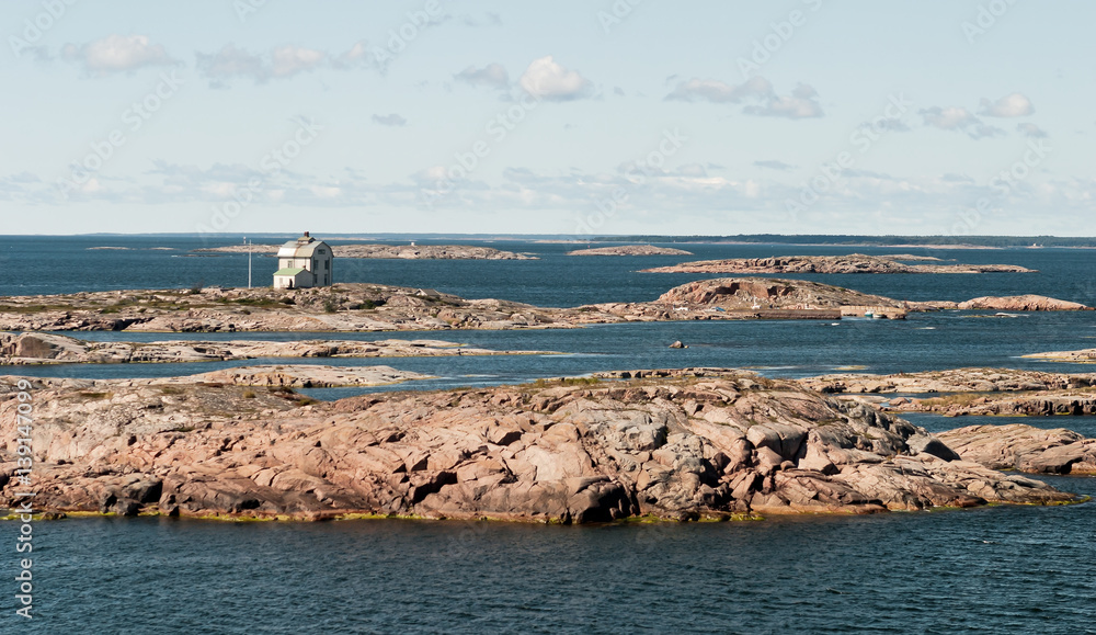 Naklejka premium Lighthouse on a small island in the archipelago of the Aland Islands, Finland