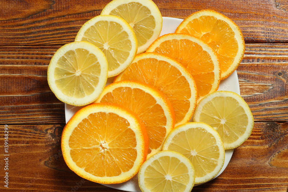 Slices orange and lemon on white Slices orange and lemon on white