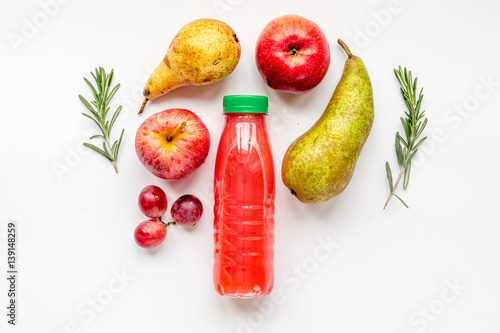plastic bottles with fruit drinks on white background top view mock up
