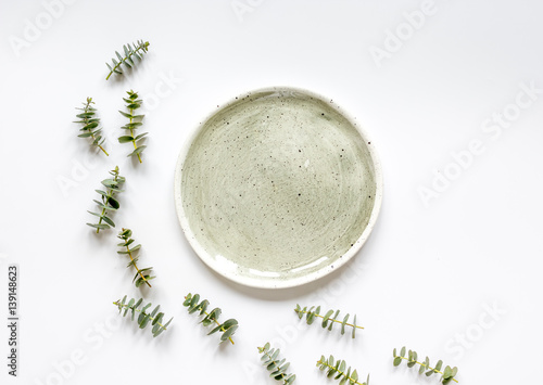Spring design with plate and eucalyptus on white background top view mockup