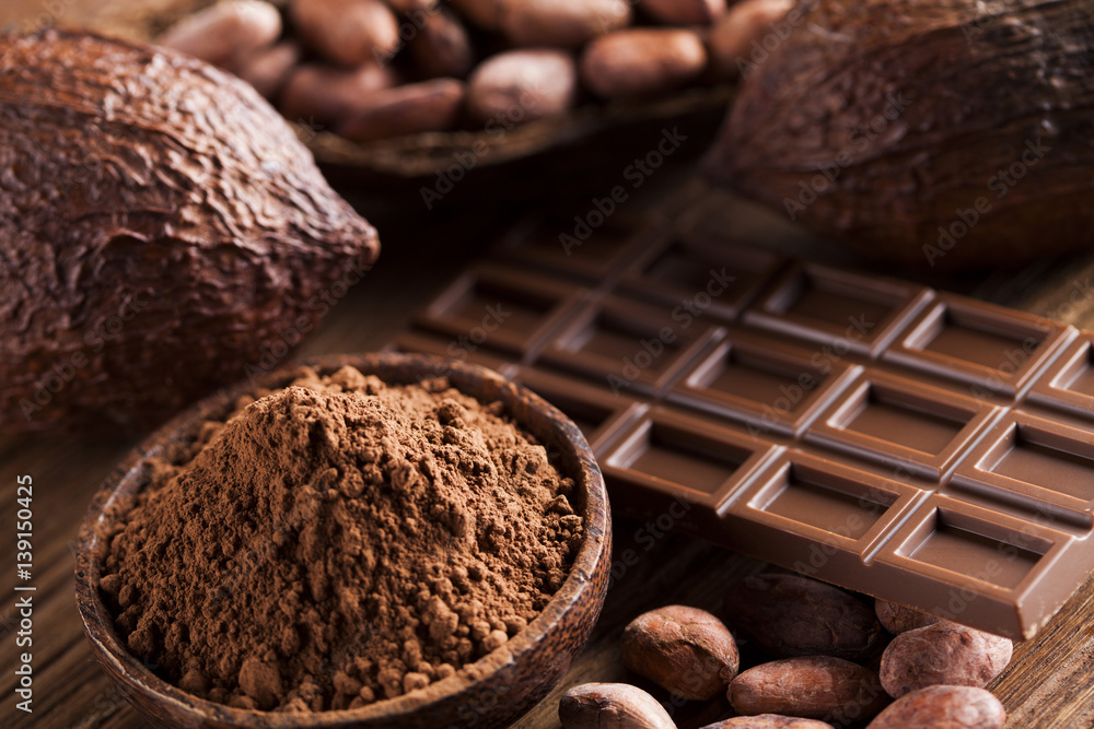Chocolate bar, candy sweet, cacao beans and powder on wooden background Chocolate bar, candy sweet, cacao beans and powder on wooden background