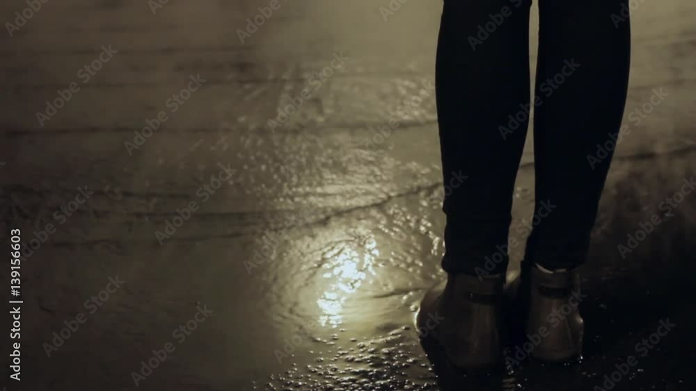 Girl freezing standing on night city road with white steam cloud on background Girl freezing standing on night city road with white steam cloud on background