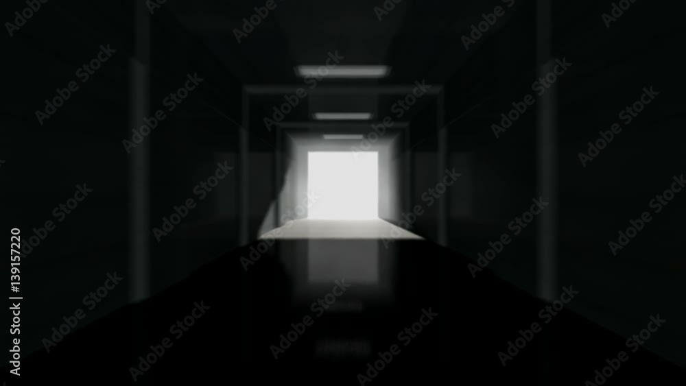 A long zoom down a dark stadium sports tunnel to enter a lit arena in the distance