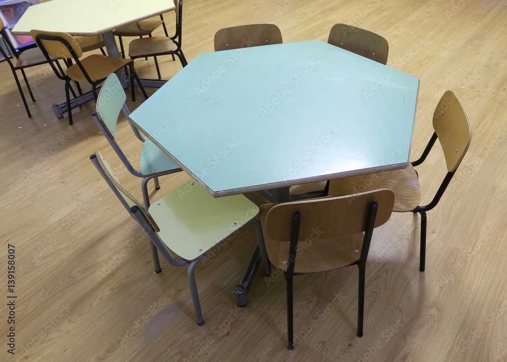 Hexagonal table with the chairs of a school class for children
