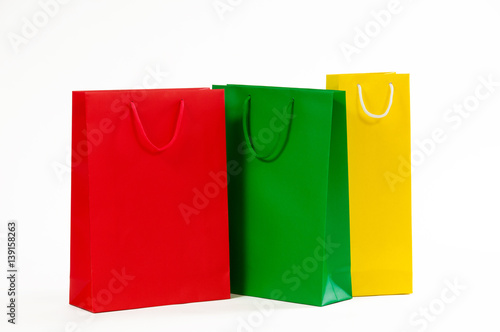 Multicolored paper shopping bag isolated on white