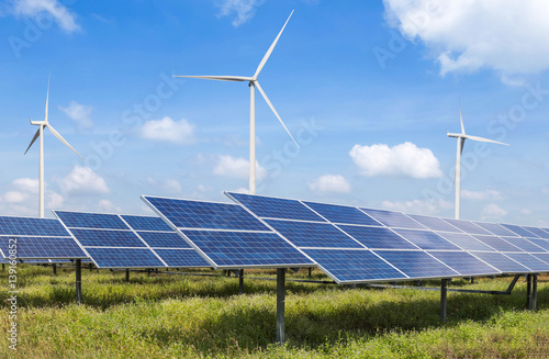 solar cells and wind turbines generating electricity in power station