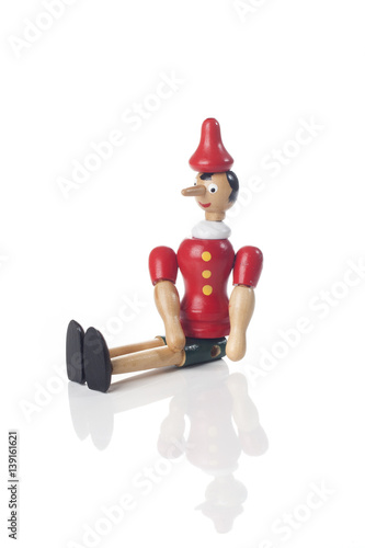 Wooden Pinocchio doll isolated on white background.