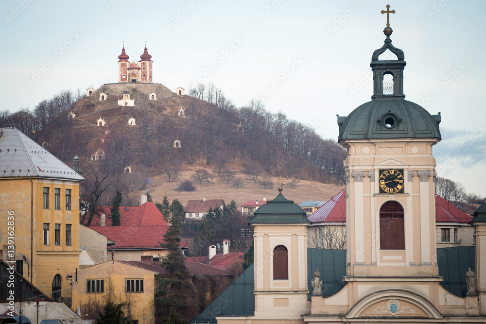 Obraz premium Parish church with Calvary Mount in background, Banska Stiavnica, Slovakia