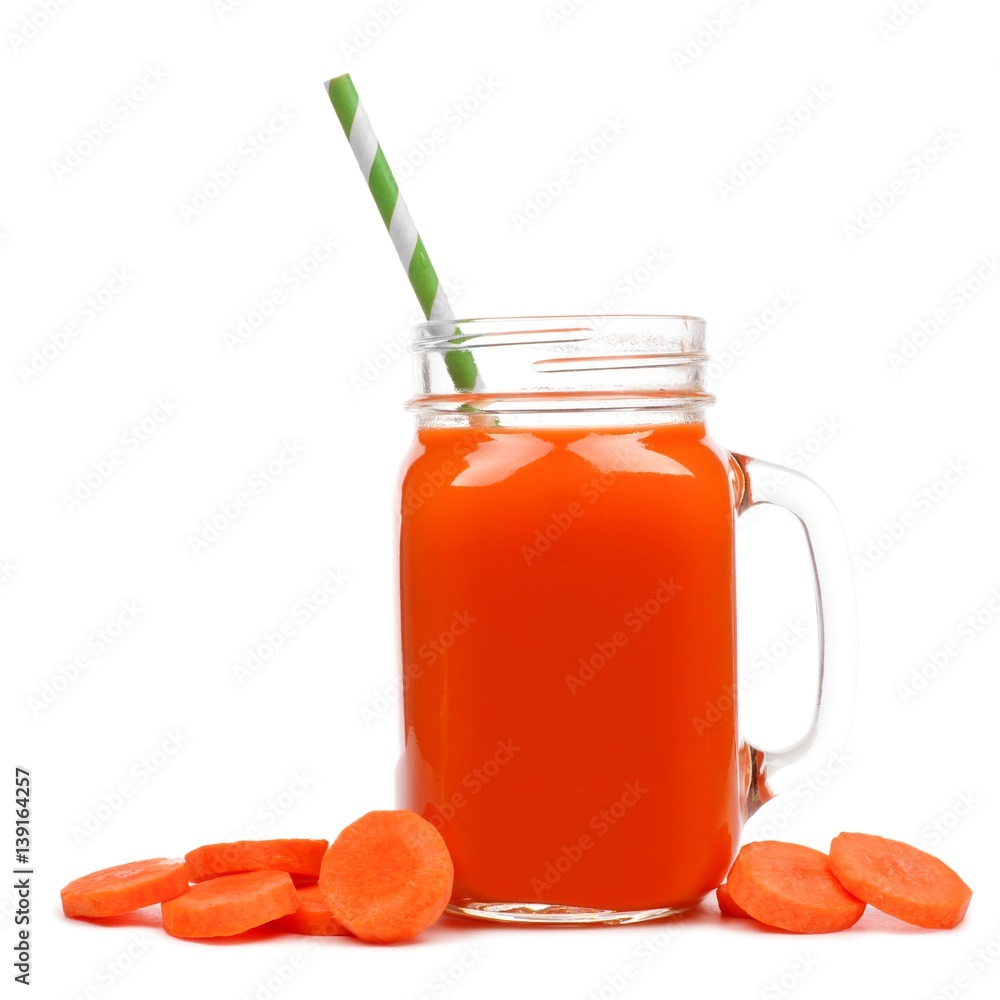 Mason jar glass of carrot juice with straw and surrounding carrot slices isolated on a white background Mason jar glass of carrot juice with straw and surrounding carrot slices isolated on a white background
