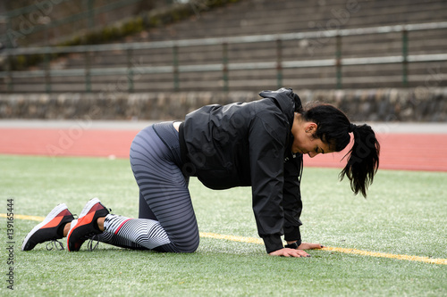 Young Female Exercising and Training at the Track