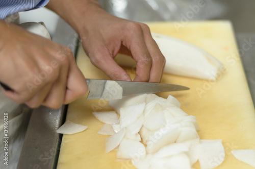 Chef cutting radish prepare food in restaurant,Hand cutting vegetable fast it's skill