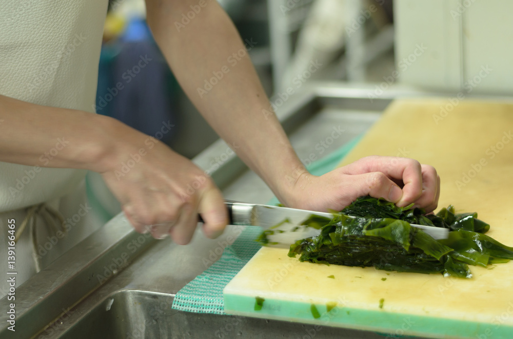 Chef cutting seaweed prepare food in restaurant,Hand cutting vegetable fast it's skill