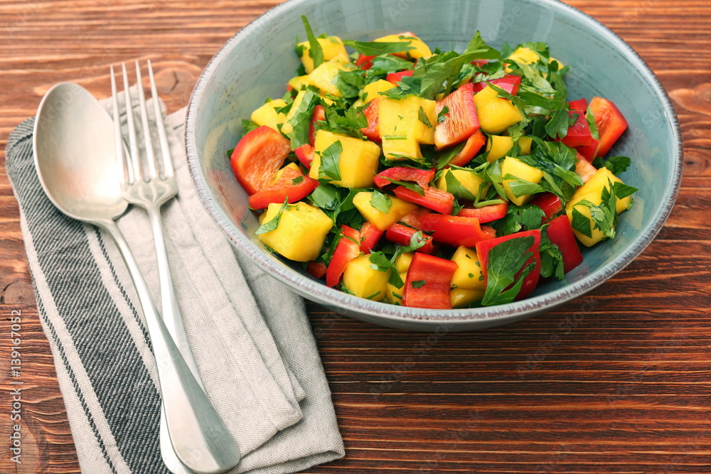 Mango salad with pepper and parsley in a bowl