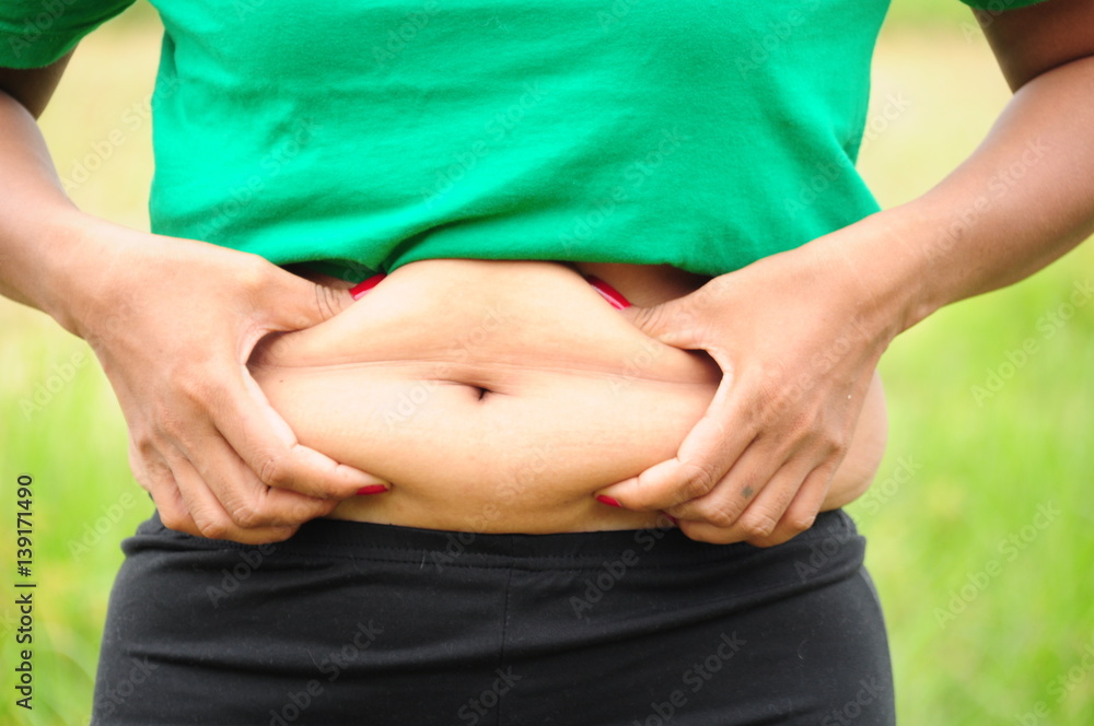 abdominal surface of fat woman on nature background, subject is blurred abdominal surface of fat woman on nature background, subject is blurred