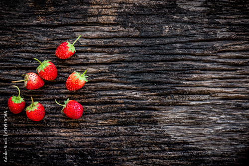 Strawberries on old wooden background