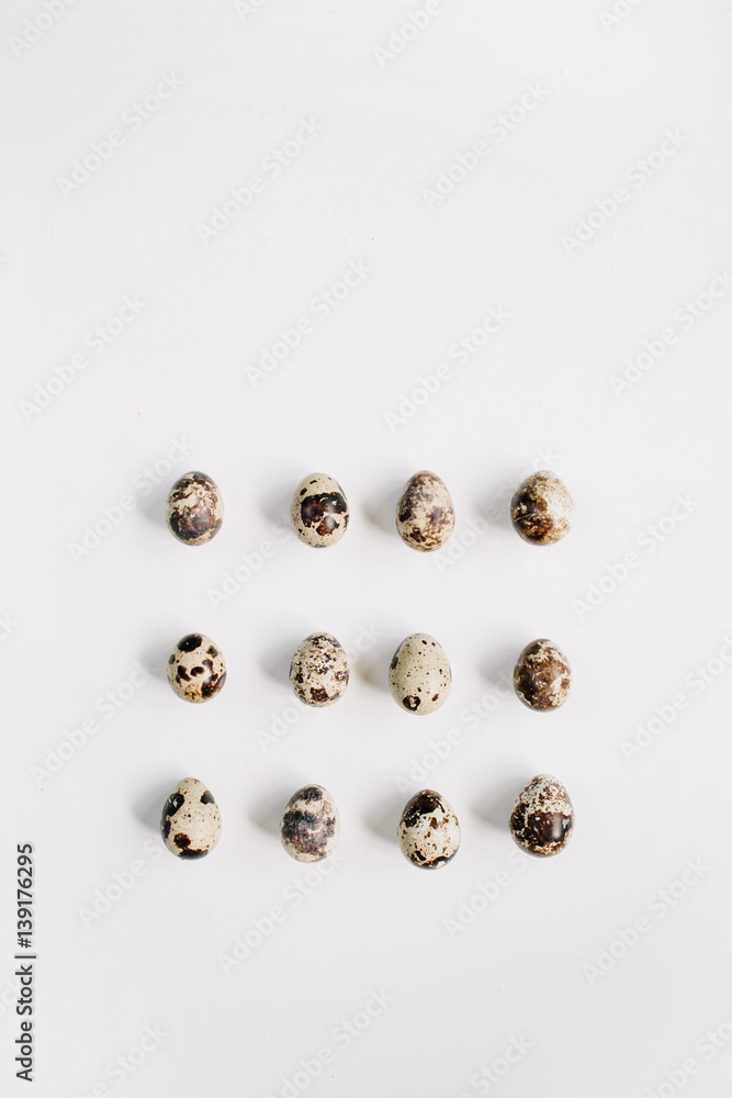 Quail eggs on white background. Flat lay, top view. Easter concept. Quail eggs on white background. Flat lay, top view. Easter concept.